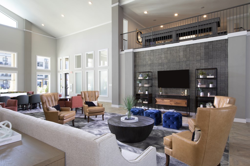 A modern living room with a fireplace and a variety of seating options.