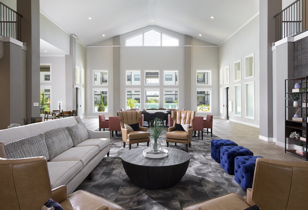 A modern living room with a large sofa, armchairs, and a coffee table.