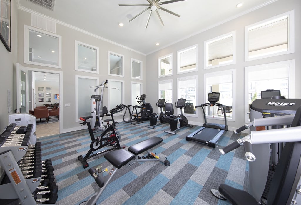 A spacious gym with a variety of equipment including treadmills, weights, and exercise machines.