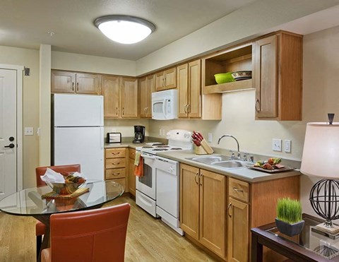 A kitchen with wooden cabinets and white appliances.