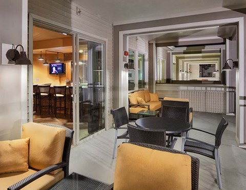 A living room with a television and a dining table.