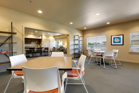 A conference room with a long table and chairs.