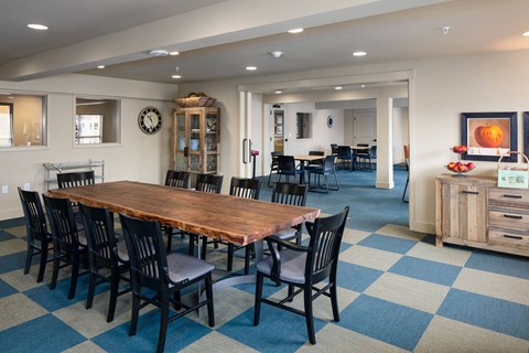 A dining room with a wooden table and chairs.
