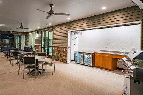 A modern kitchen with a dining table and chairs.