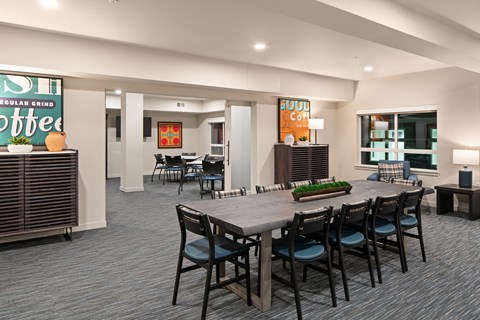 A modern dining room with a large table and chairs.