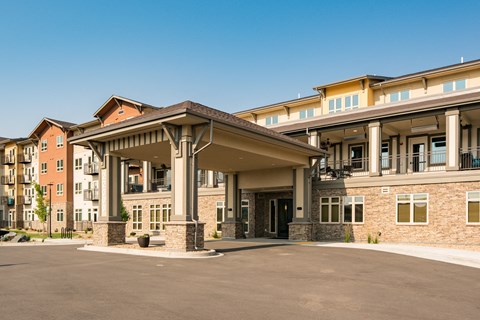 A large building with a covered walkway in front.