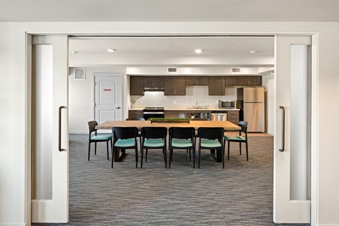 A kitchen with a table and chairs in the middle of the room.