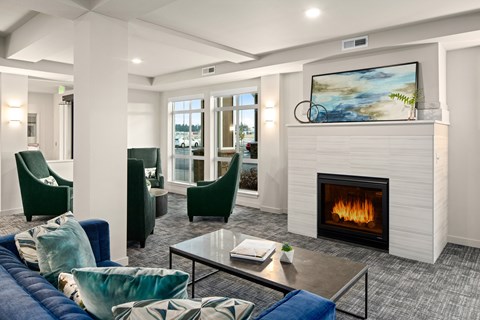 A modern living room with a fireplace and a painting on the wall.