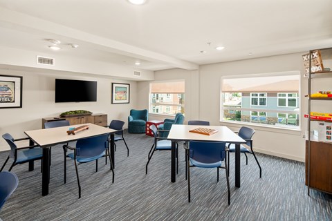 A conference room with a long table and chairs.
