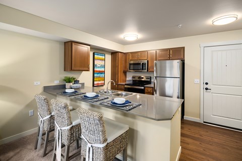 A kitchen with a table and chairs.