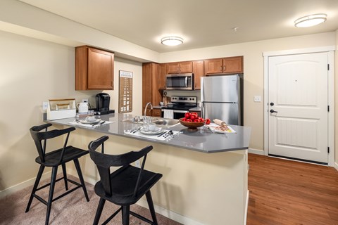 A kitchen with a table and chairs.