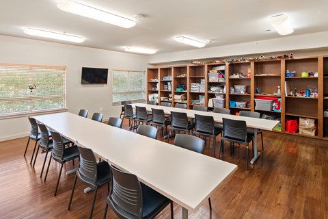 A conference room with a long table and chairs.