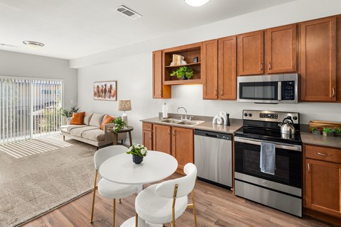 A modern kitchen with wooden cabinets and stainless steel appliances.