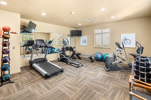 A spacious gym with a variety of exercise equipment.