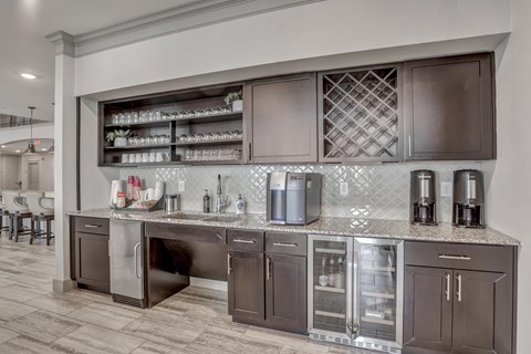 A kitchen with brown cabinets and a marble countertop.