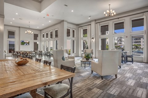 A large dining room with a wooden table and chairs.