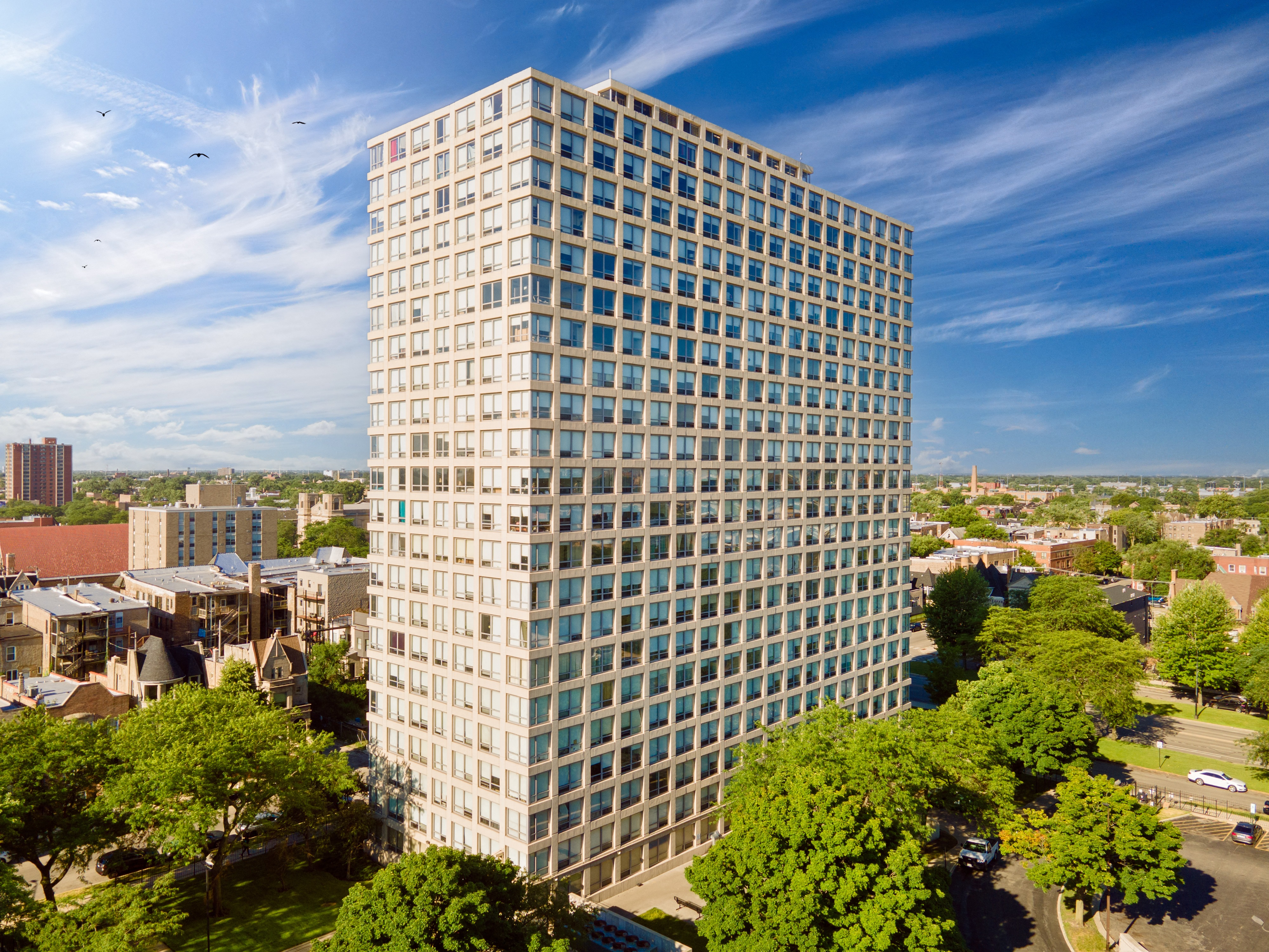 an aerial view of a tall building in a city