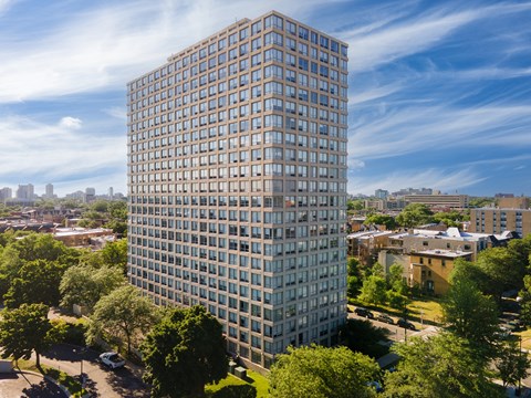 an aerial view of a tall building in a city