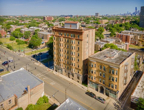 A city street with a large building in the middle.