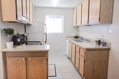 a kitchen with wooden cabinets and a counter top