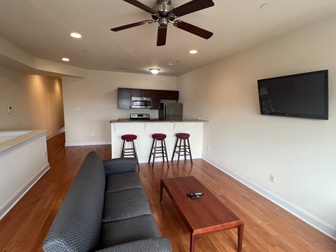 A living room with a grey couch and a wooden coffee table.