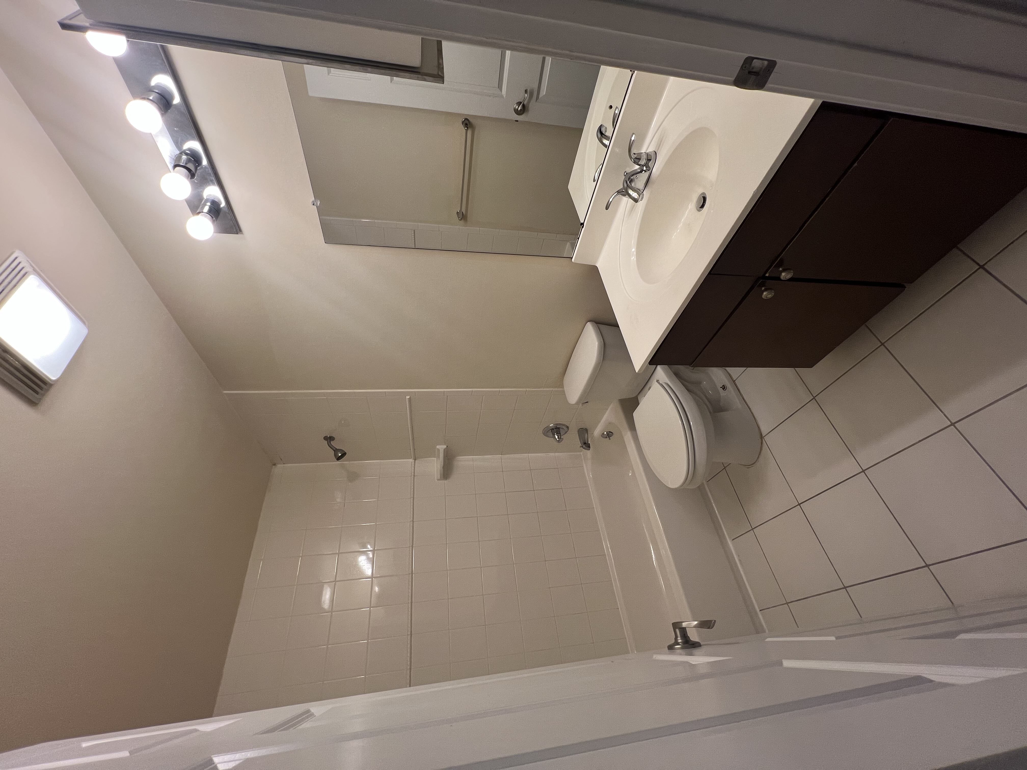 A bathroom with a white sink and a white toilet.