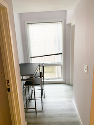 A room with a desk and a chair in it.