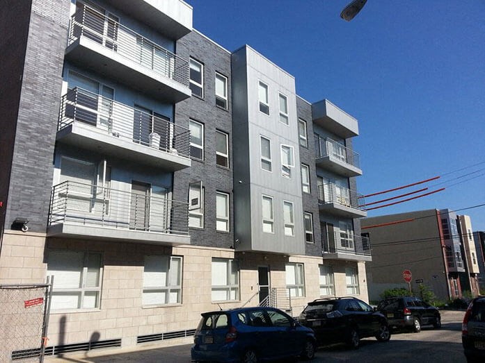 an apartment building with cars parked in front of it