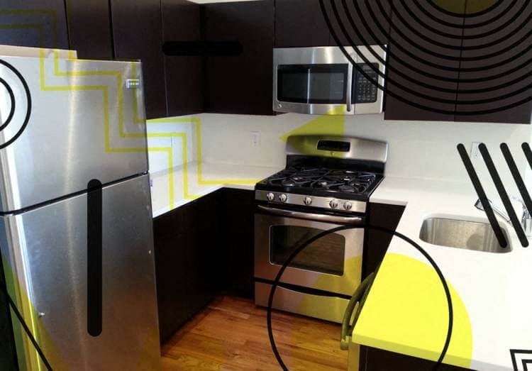 a kitchen with a stove a refrigerator and a microwave