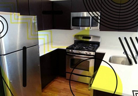 A modern kitchen with a stainless steel refrigerator and a yellow accent.