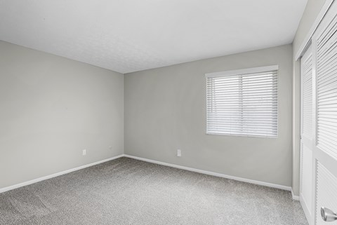 A room with a window and a door.