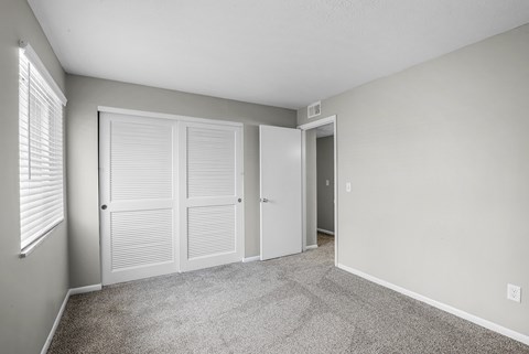 A room with a carpeted floor and white walls.