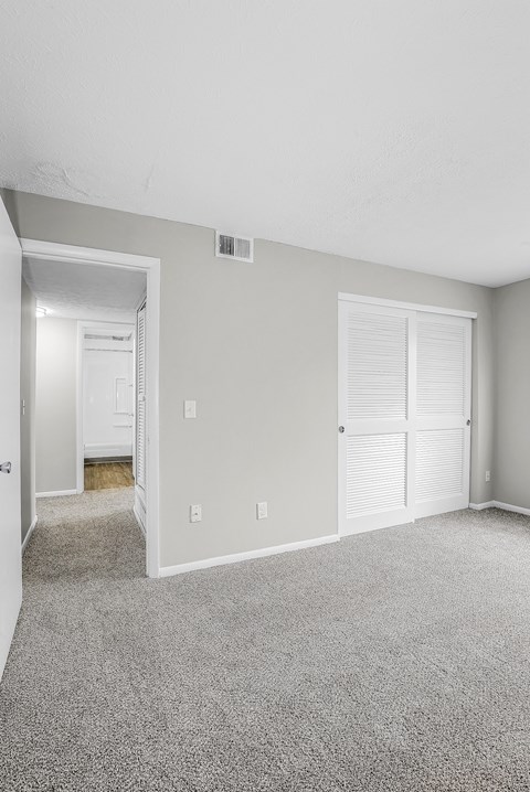 A room with a carpeted floor and white walls.