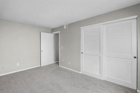 A room with a carpeted floor and white walls.