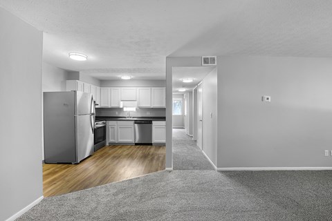 A kitchen with a refrigerator, sink, and oven.