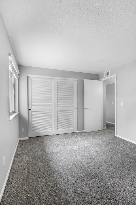 A room with a carpeted floor and white walls.
