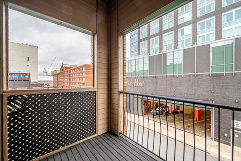 a balcony with a view of a building and a street