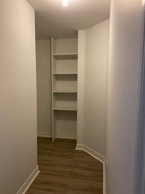 a room with a closet and shelves in it