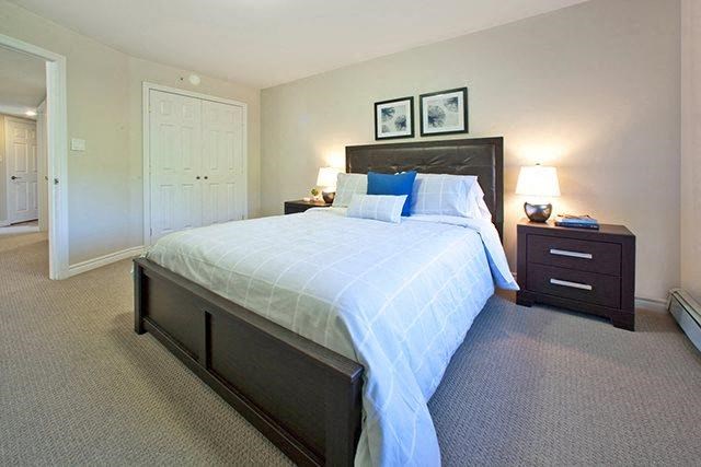 a bedroom with a bed and two night stands