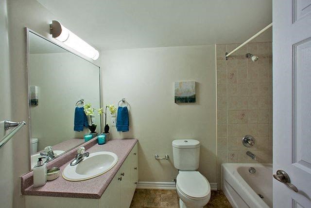 a bathroom with a sink and a toilet and a shower