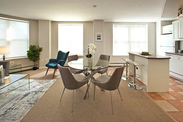 a dining room with a glass table and chairs