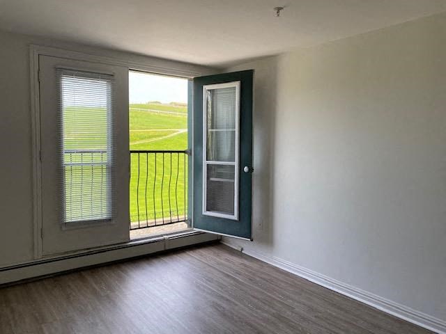 an empty living room with a door and a balcony