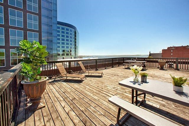 a large deck with a table and chairs on it