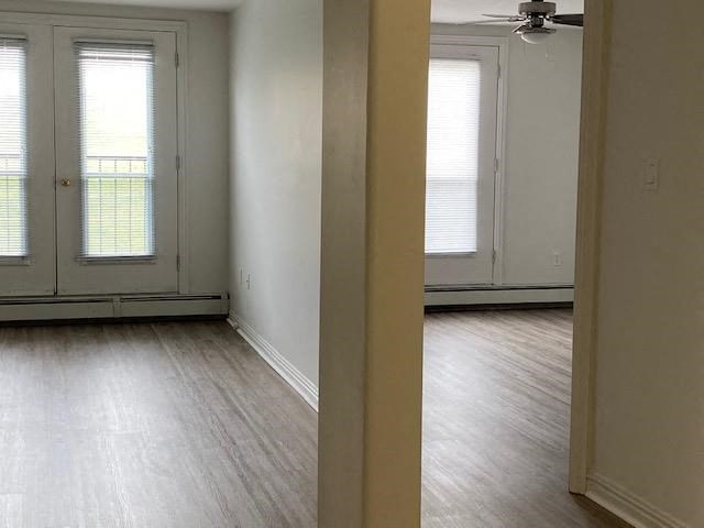 an empty living room with white walls and wood floors