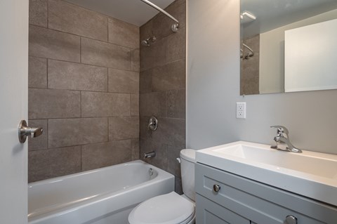 a bathroom with a sink toilet and a tub