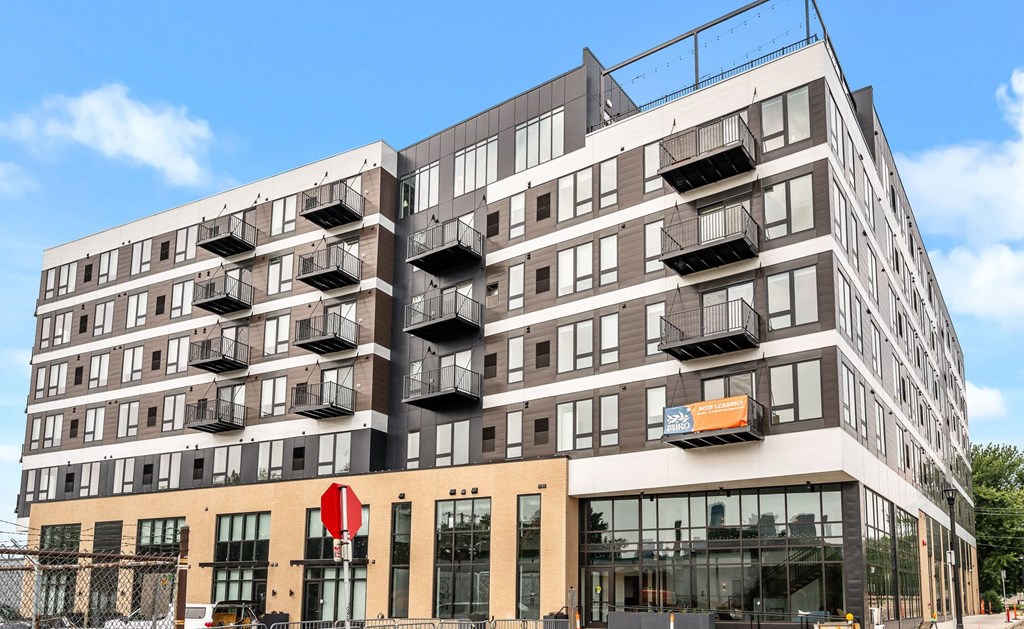 a large apartment building with balconies on the side of it