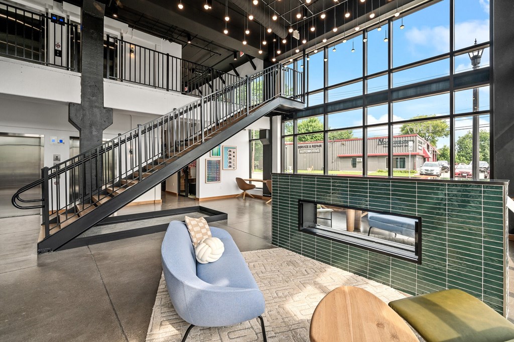 a lobby with a fireplace and a staircase