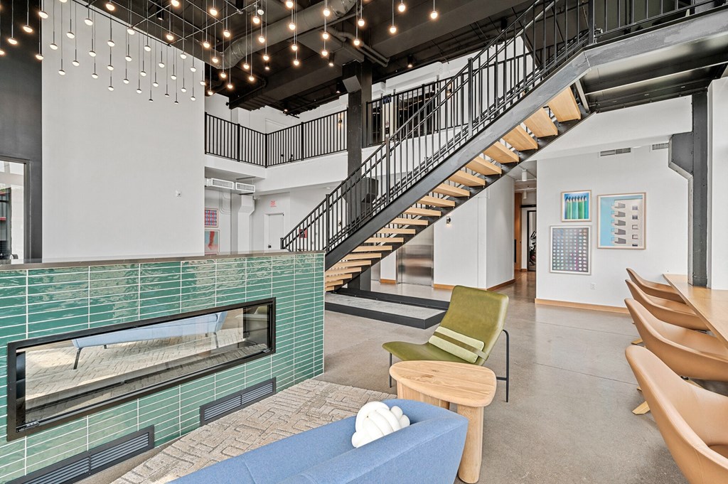 a living room with a fireplace and stairs