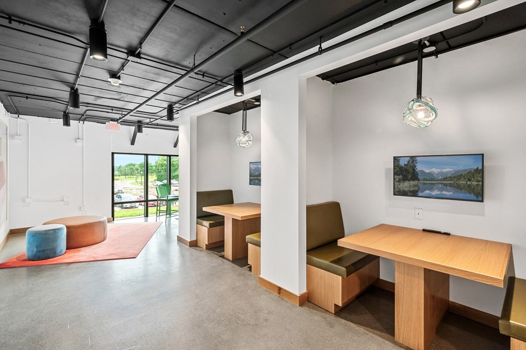 study or wfh space with tables and chairs and a tv