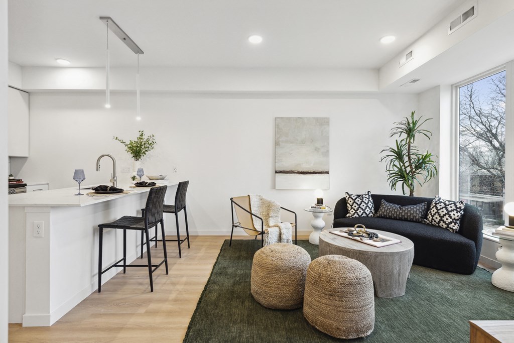 a living room with a kitchen and a couch and a table